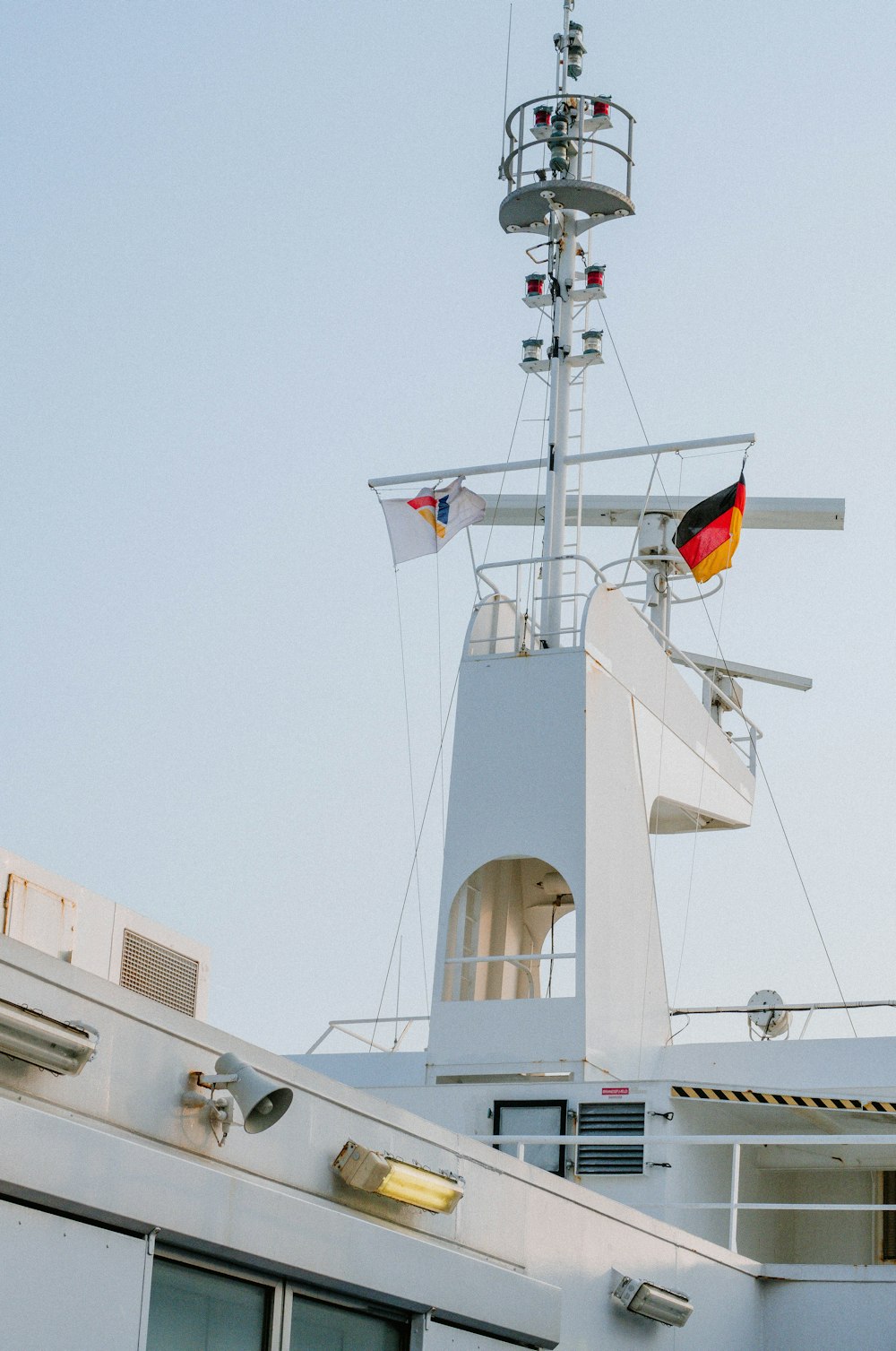 a large white boat with a flag on top of it