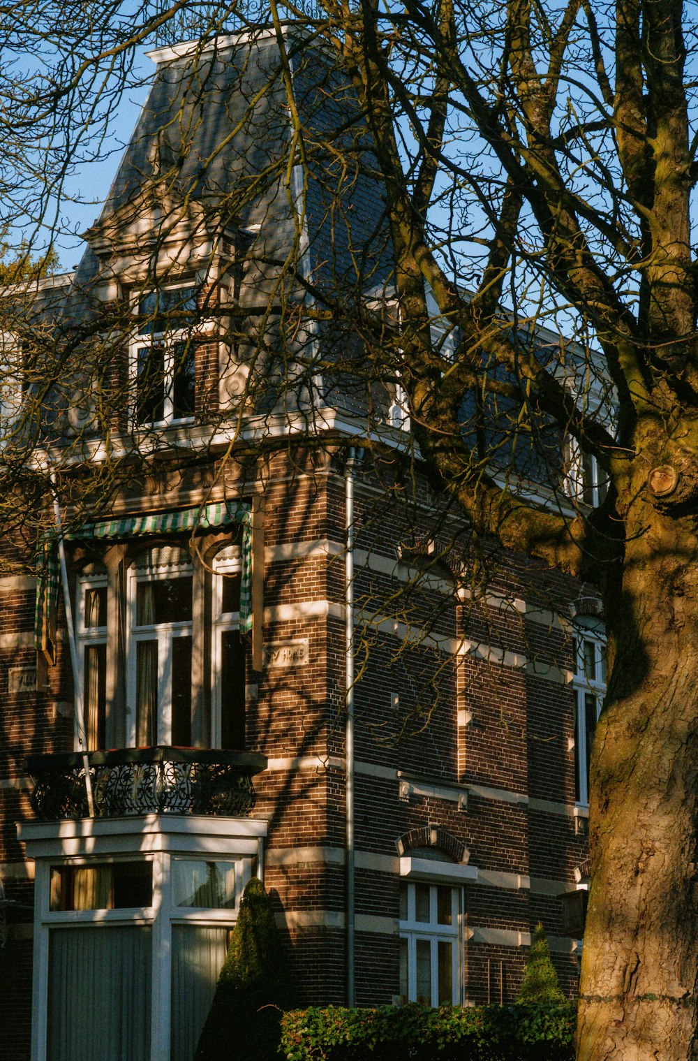 a tall brick building with a clock on the front of it