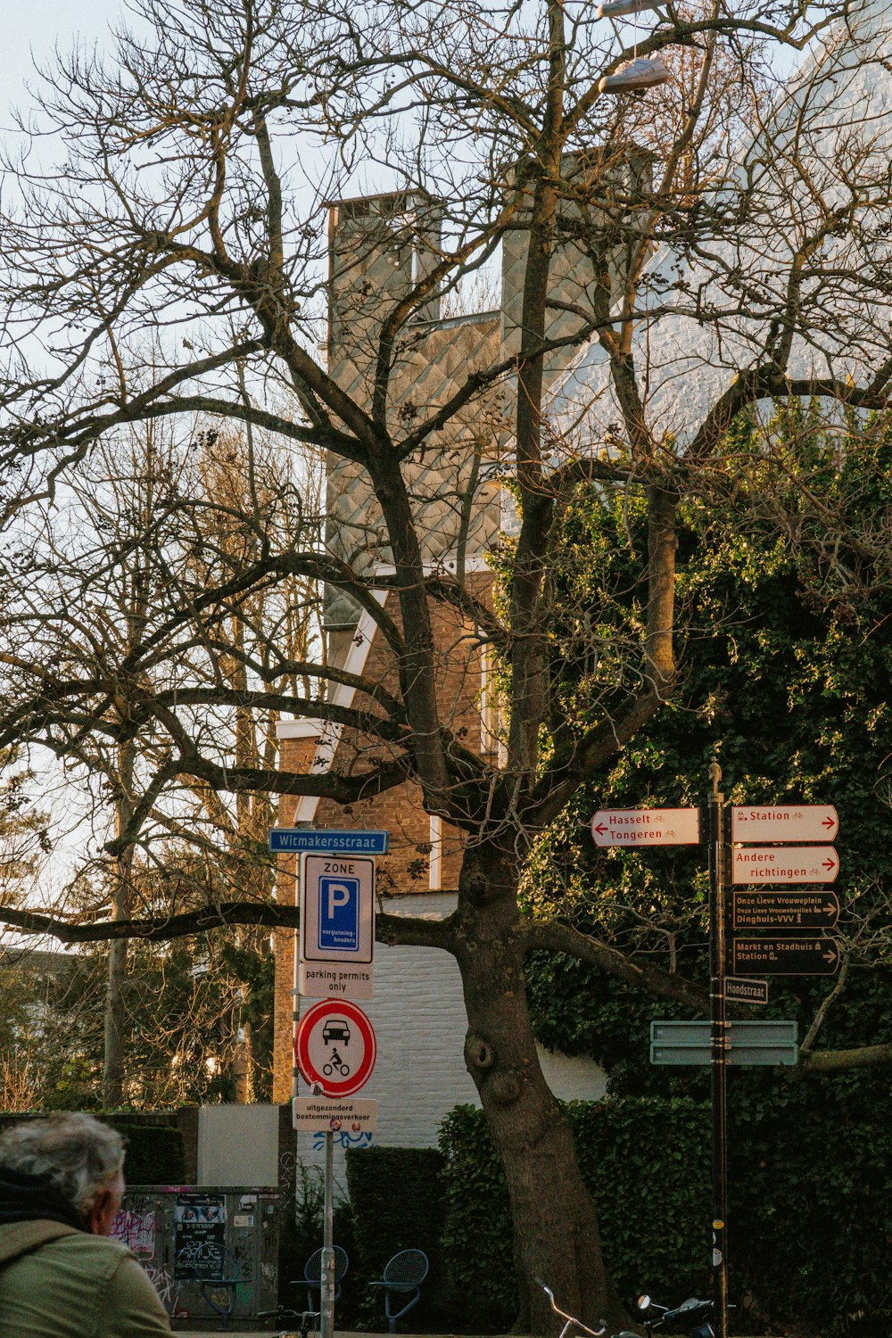 a man riding a bike down a street next to a tall building