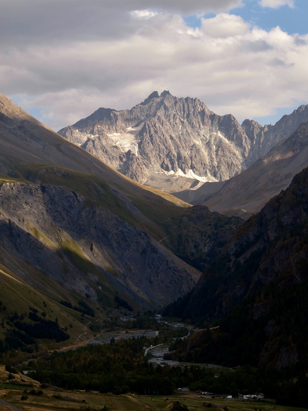 a view of a valley with mountains in the background