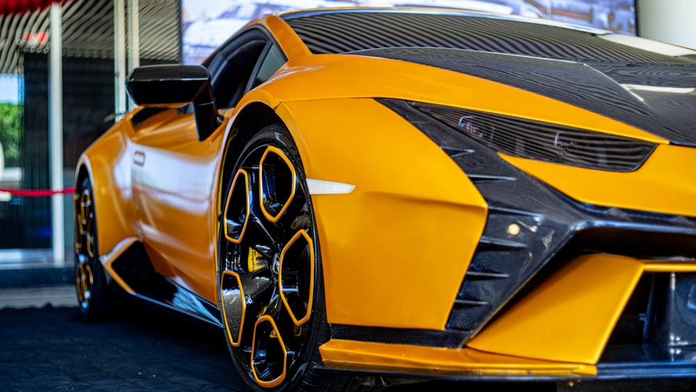 a yellow sports car parked in front of a building