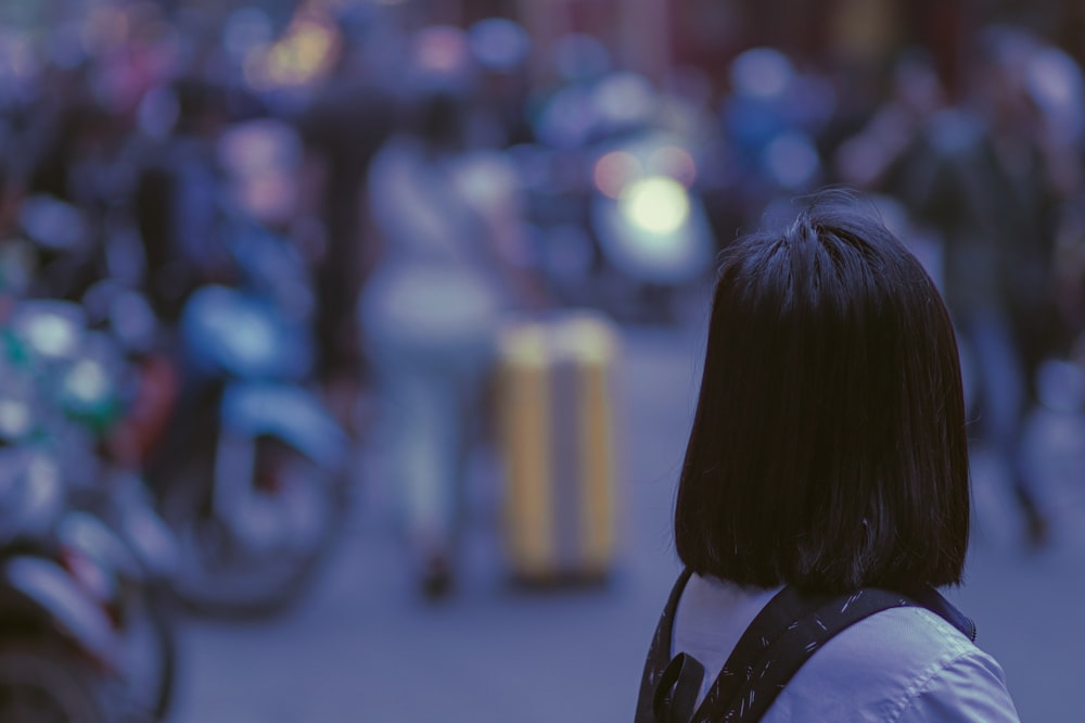 a woman standing in front of a crowd of motorcycles