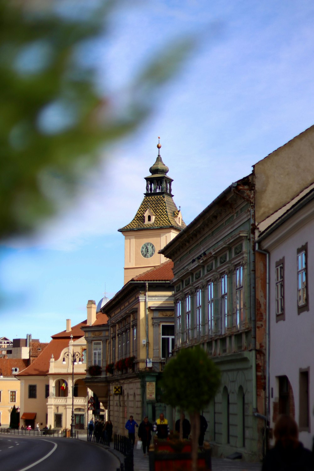 a clock tower on top of a building on a street