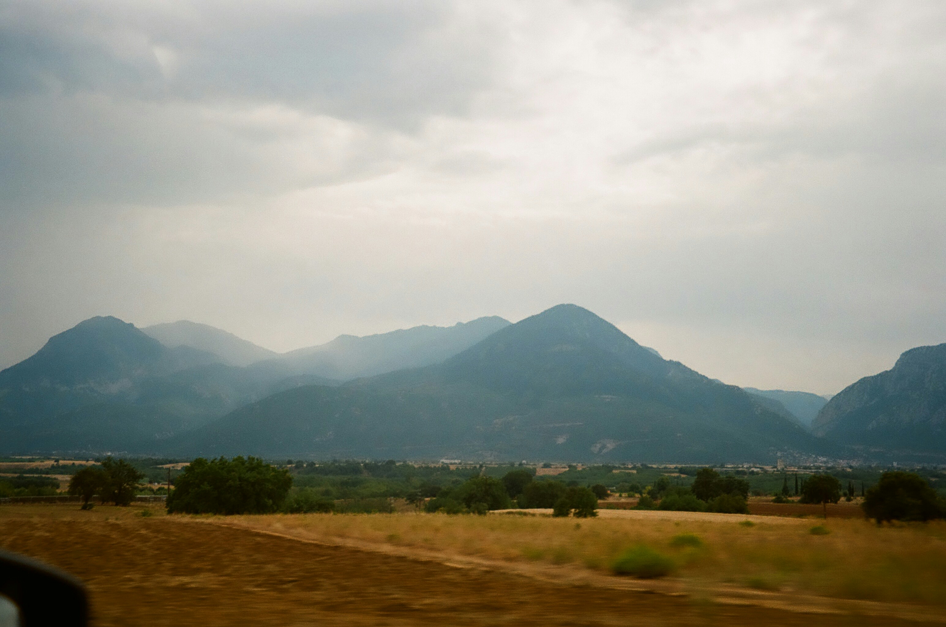 a view of a mountain range from a moving vehicle