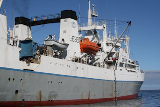 a large boat floating on top of a body of water