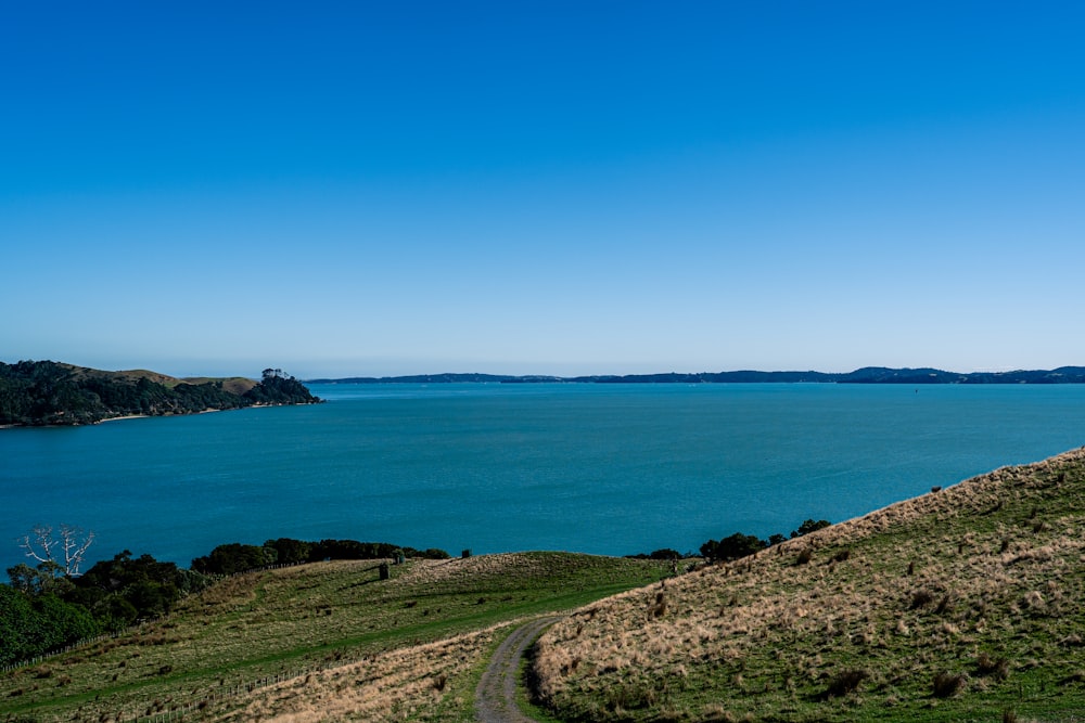 a scenic view of a body of water from a hill