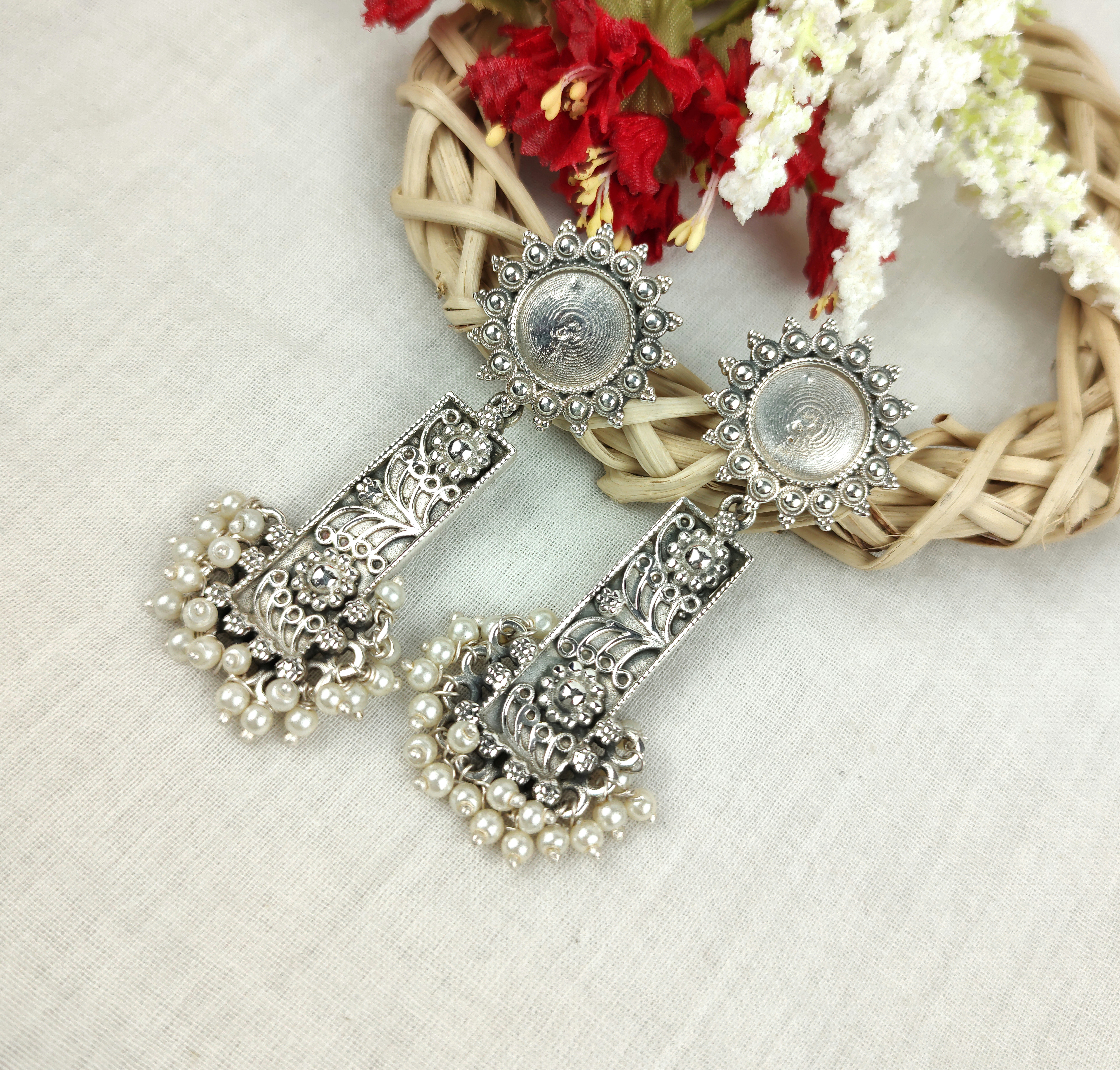 Pearl drop earrings on white background, boutique jewelry product photography