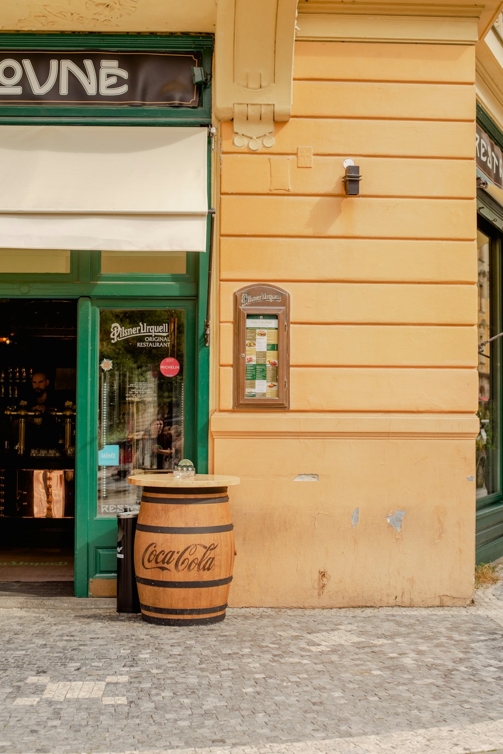 a store front with a barrel outside of it