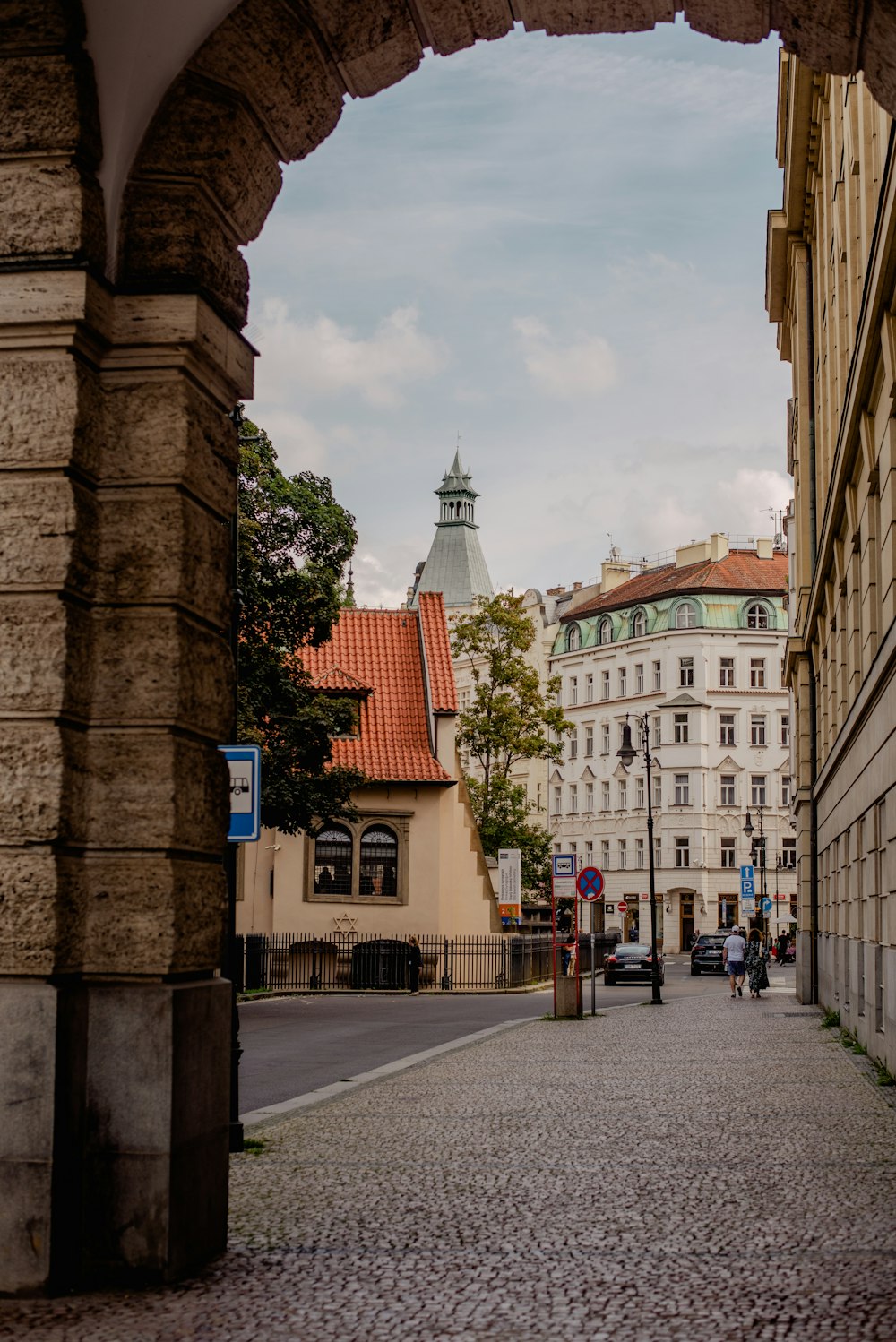 a view of a street through an arch in a building