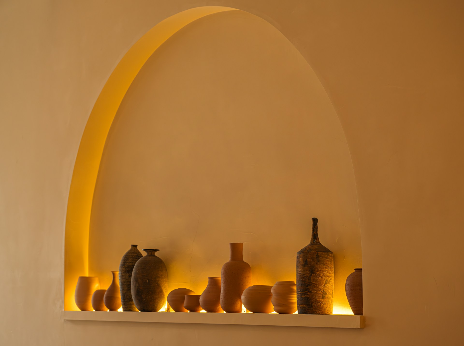 a group of vases sitting on top of a shelf