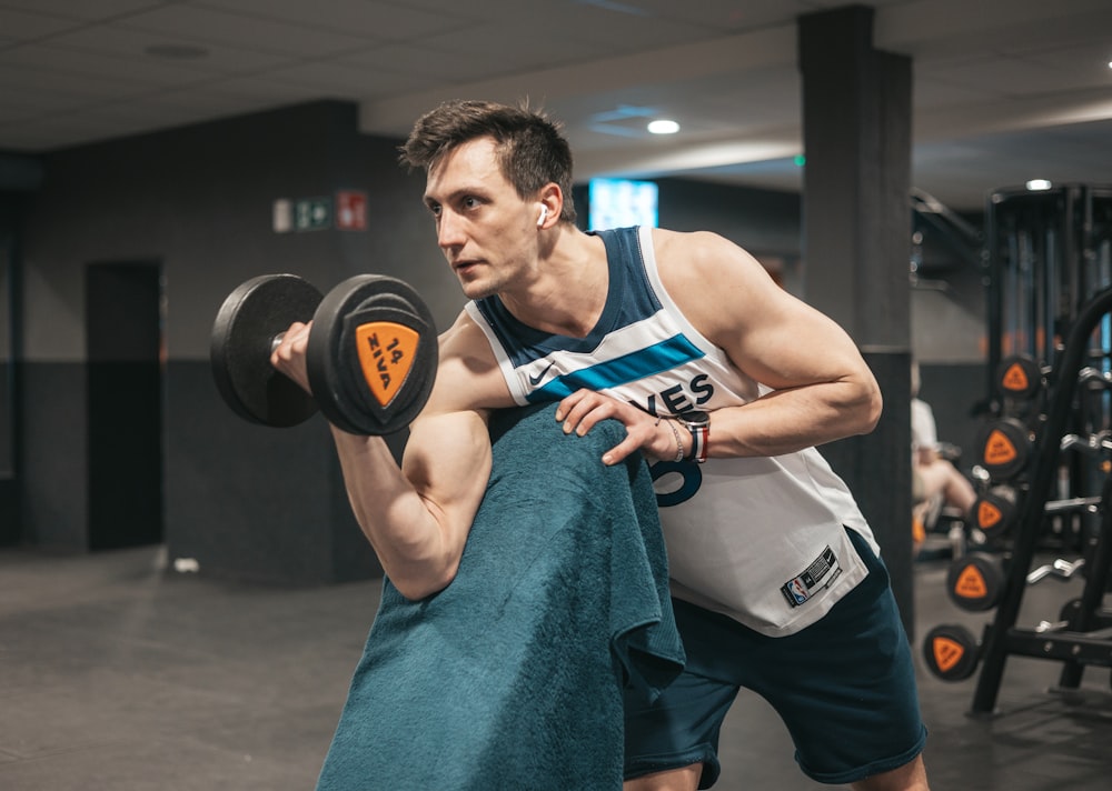 a man lifting a dumbbell in a gym