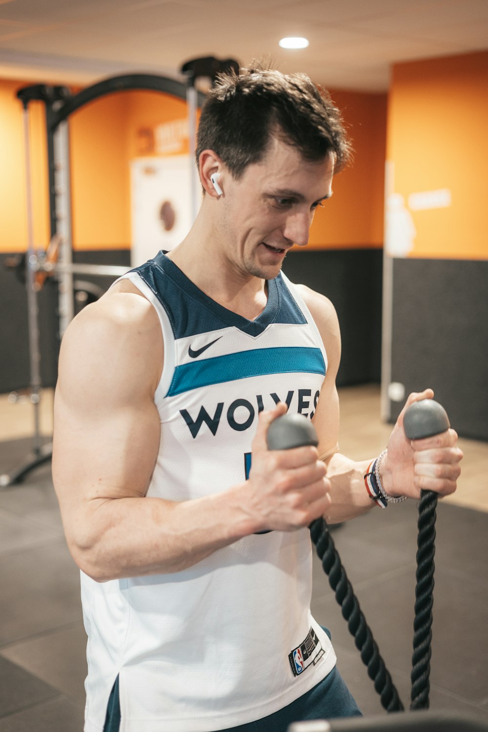 a man holding a rope in a gym