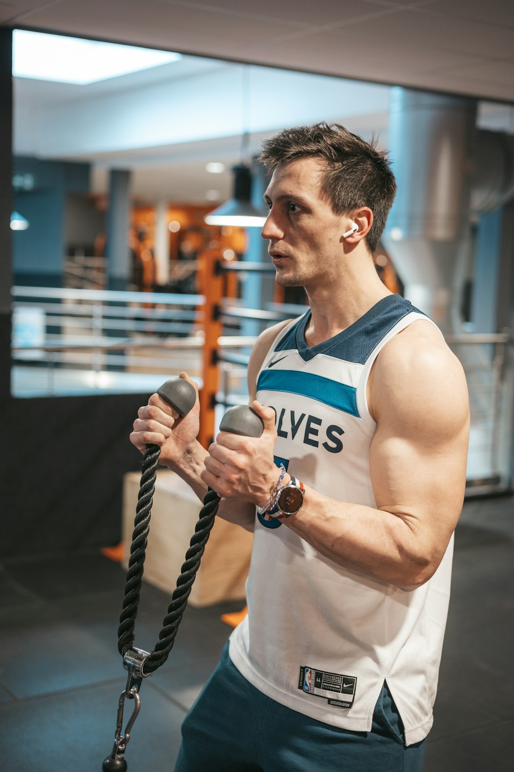 a man holding a rope in a gym