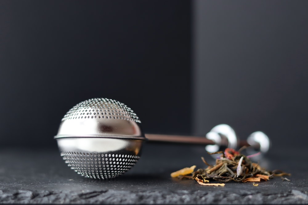 a tea ball and a tea strainer on a table