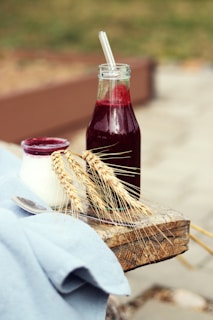 a bottle of juice and a spoon on a table