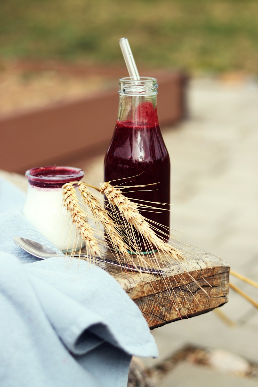 a bottle of juice and a spoon on a table