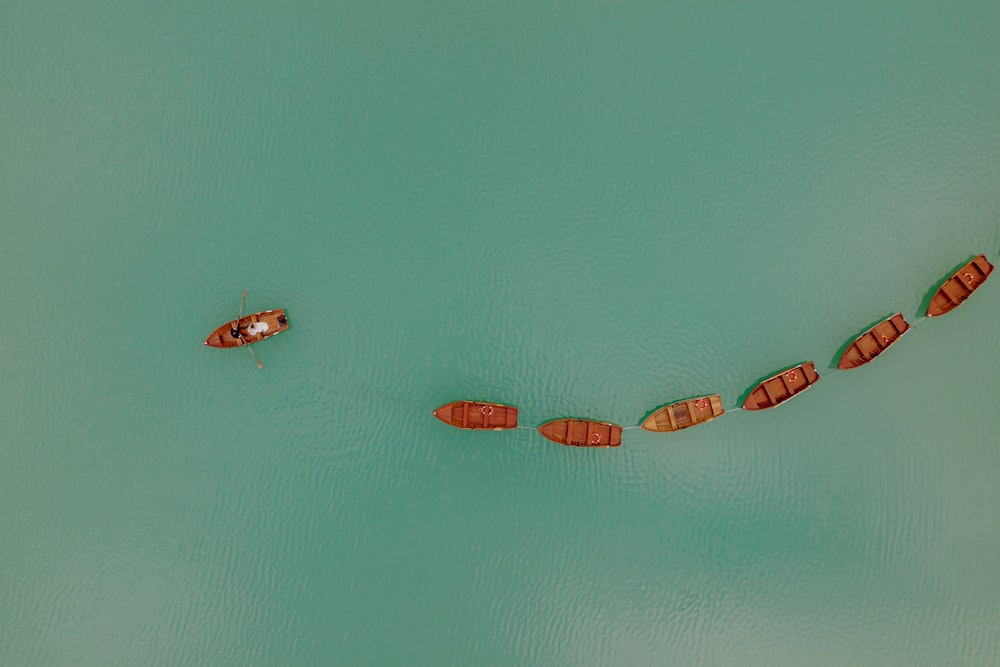 a group of boats floating on top of a body of water