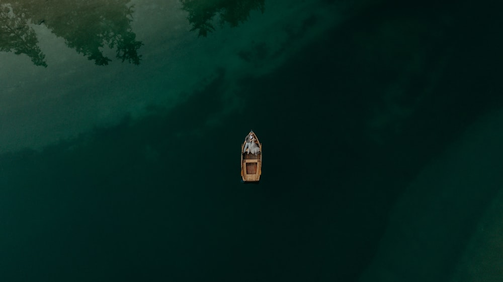 a small boat floating on top of a body of water