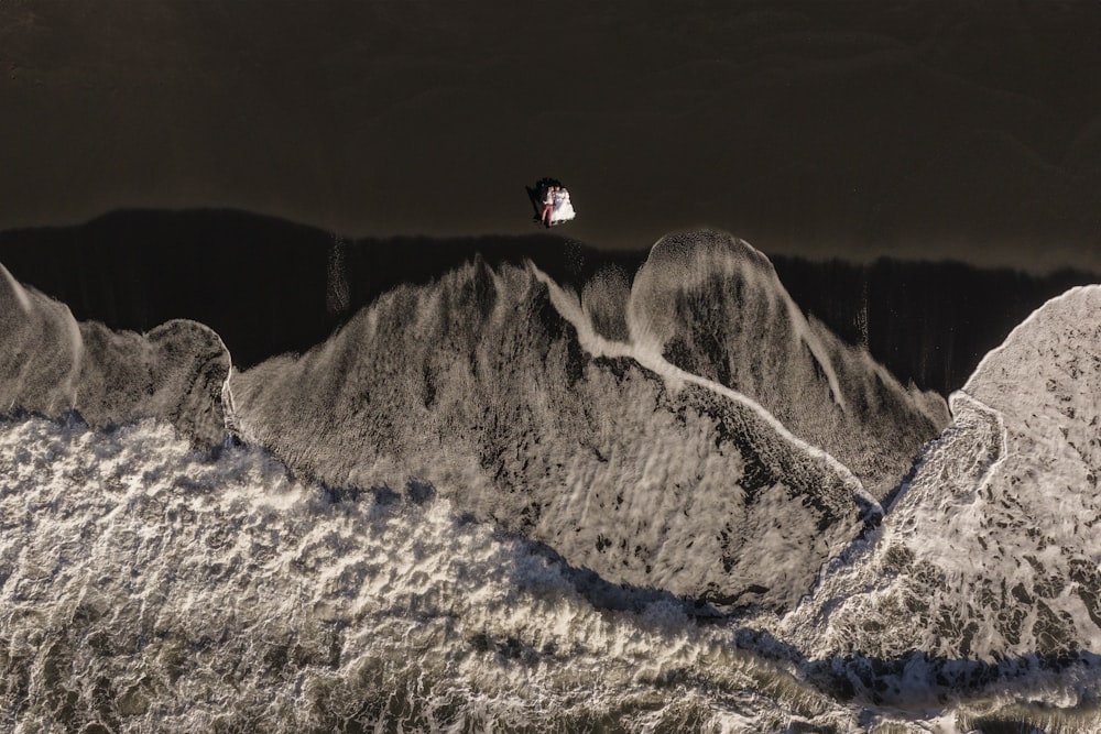 a man flying through the air while riding a snowboard