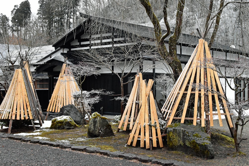 a group of wooden poles sitting in front of a building