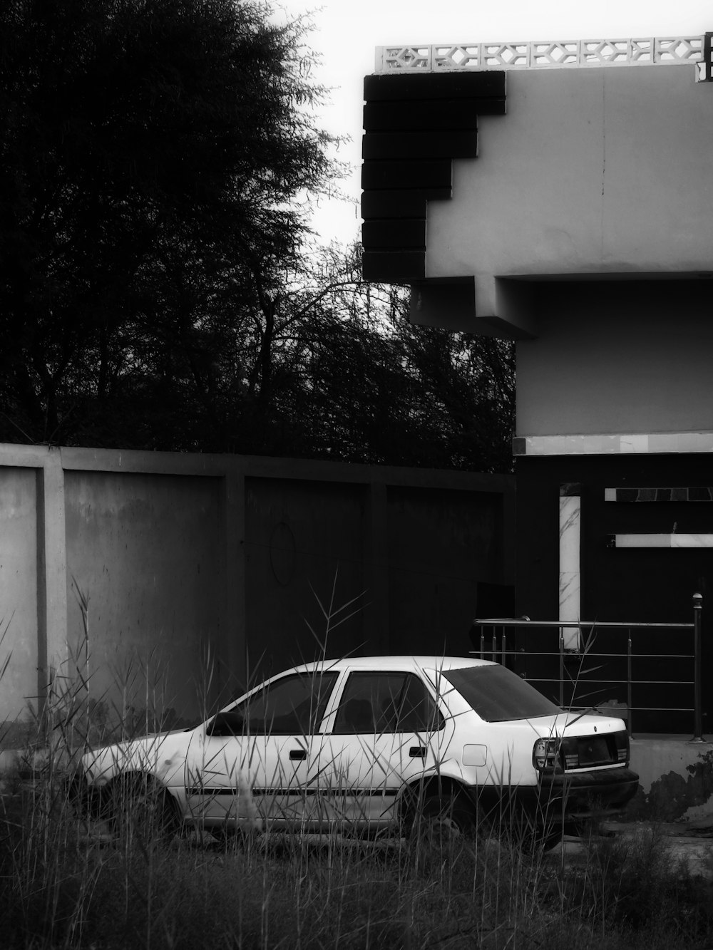 a white car parked in front of a building