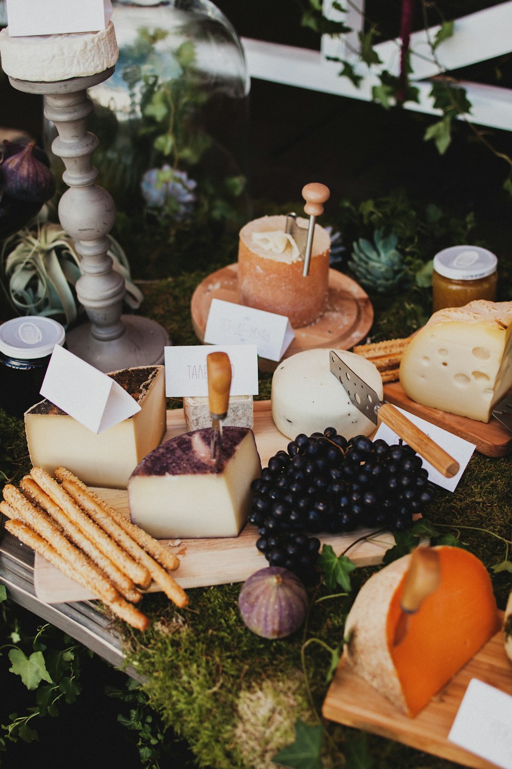 a variety of cheeses and cheese sticks on a table