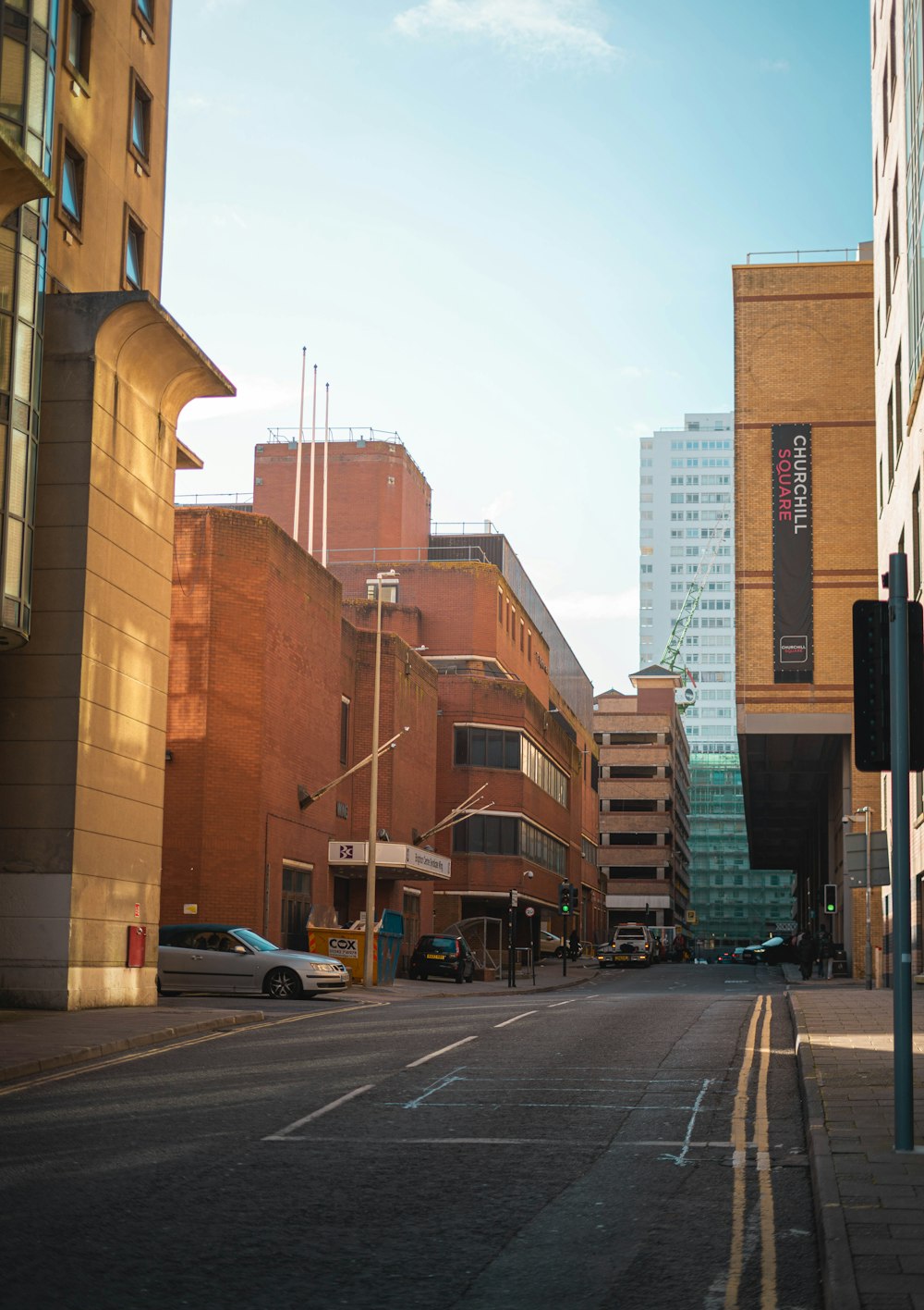 a city street with tall buildings on both sides