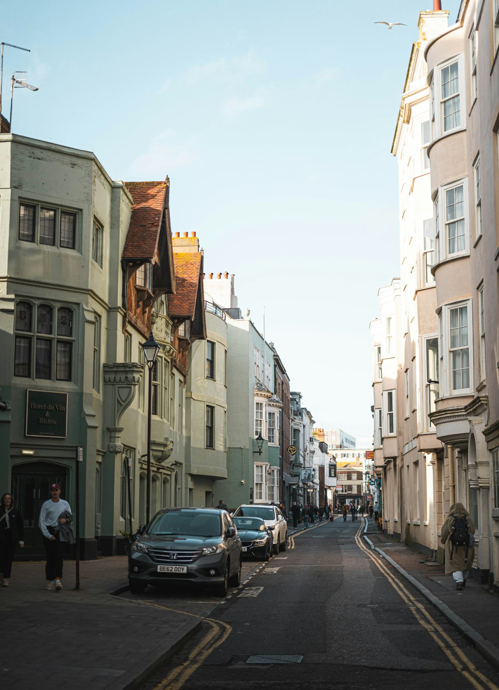 a city street with cars parked on both sides of the street