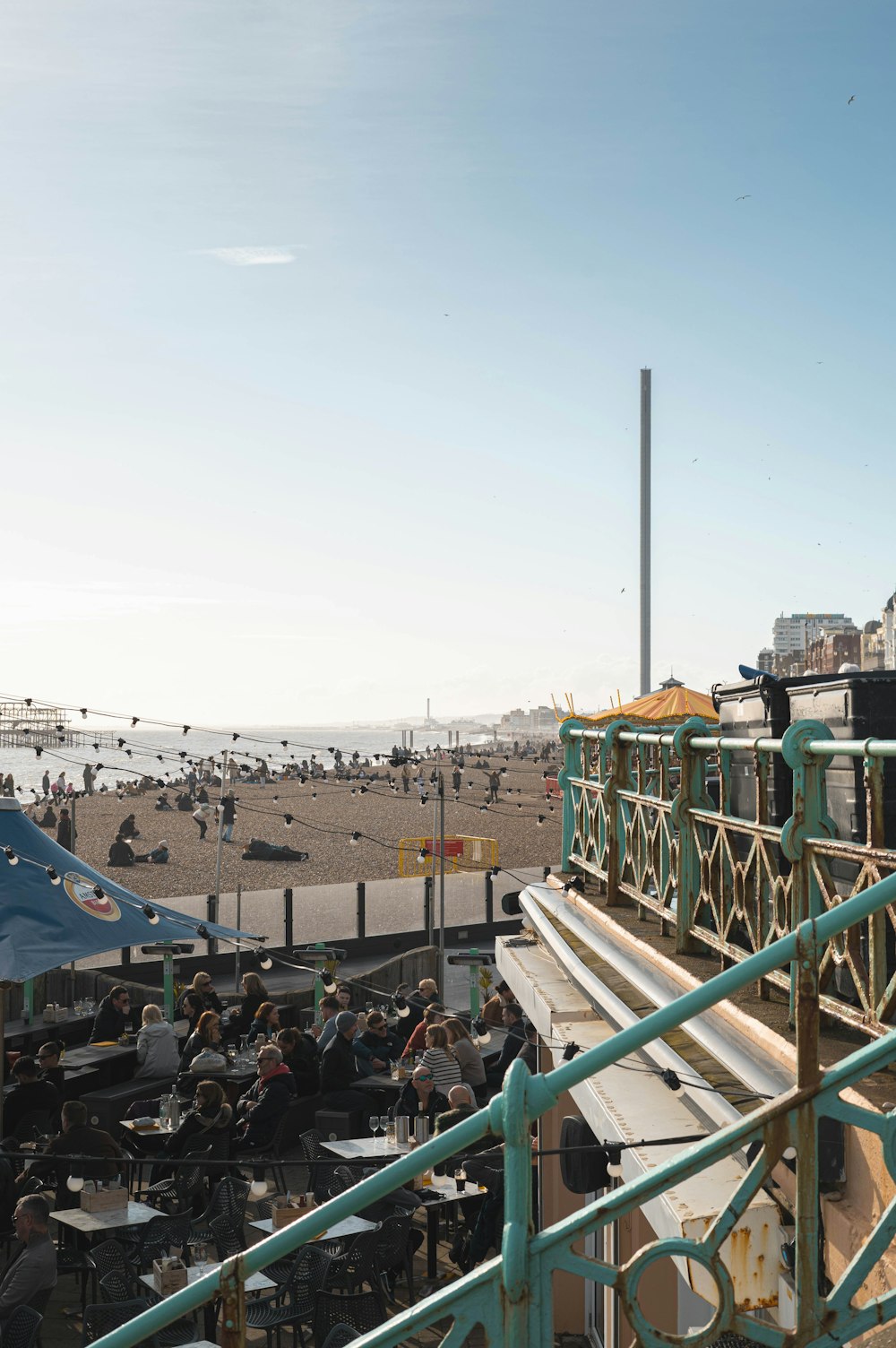 a group of people sitting at a table on a beach