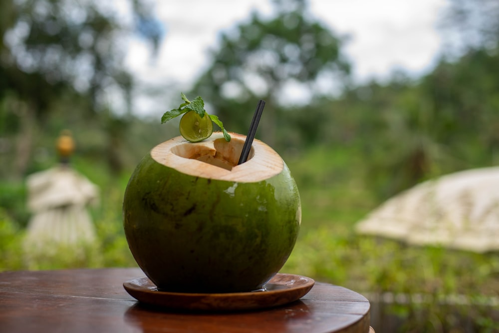 a green drink sitting on top of a wooden table