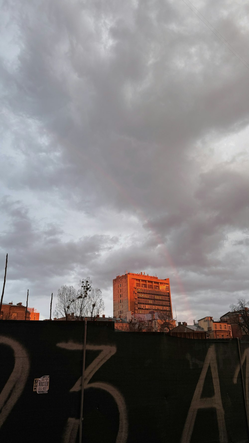 a rainbow appears in the sky over a city