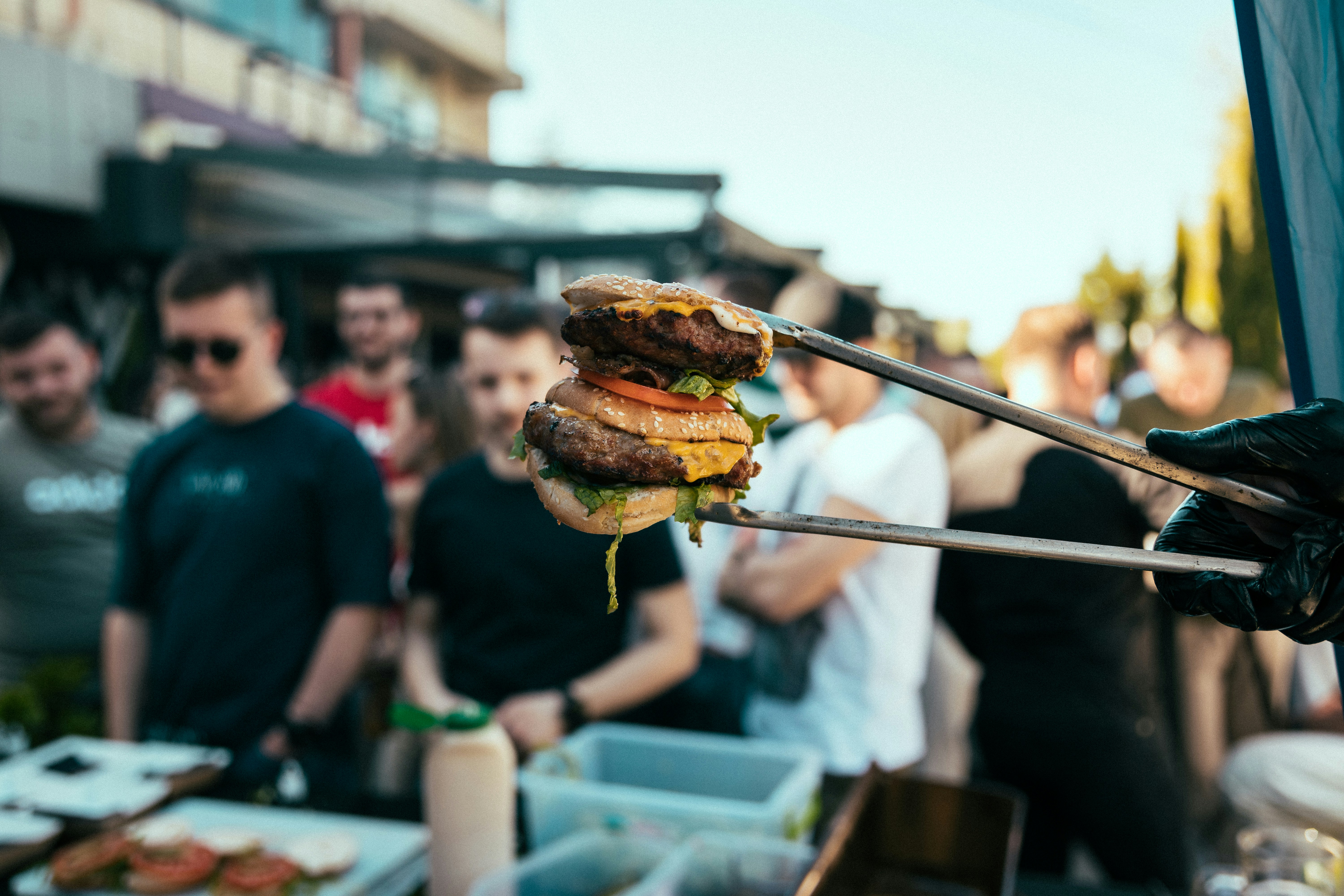 a person holding a large sandwich on a fork