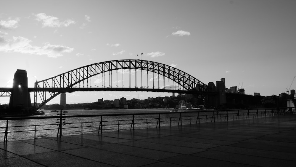 a black and white photo of a bridge over water