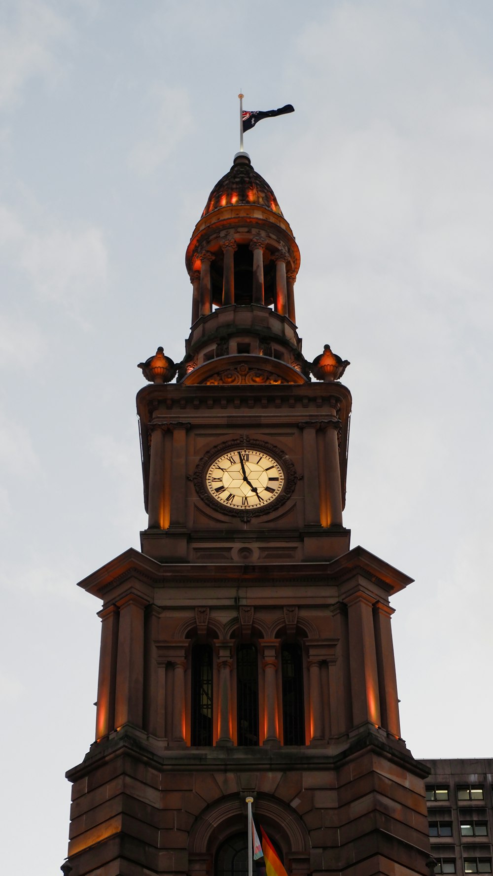 a clock tower with a flag on top of it