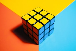 a rubik cube sitting on top of a colorful surface