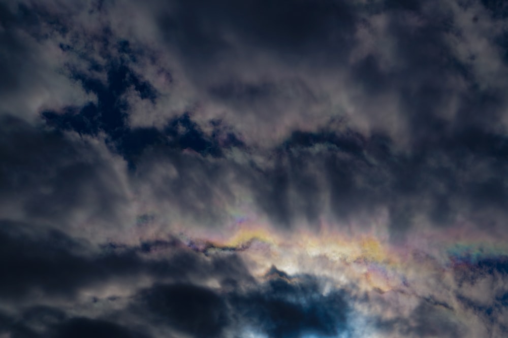 a rainbow appears in the clouds as it shines