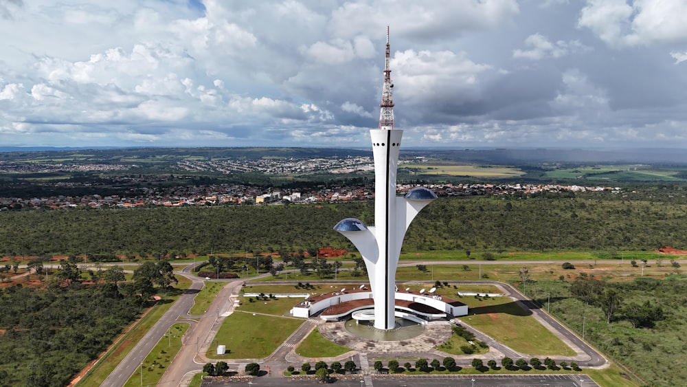 an aerial view of a tall building in the middle of a field