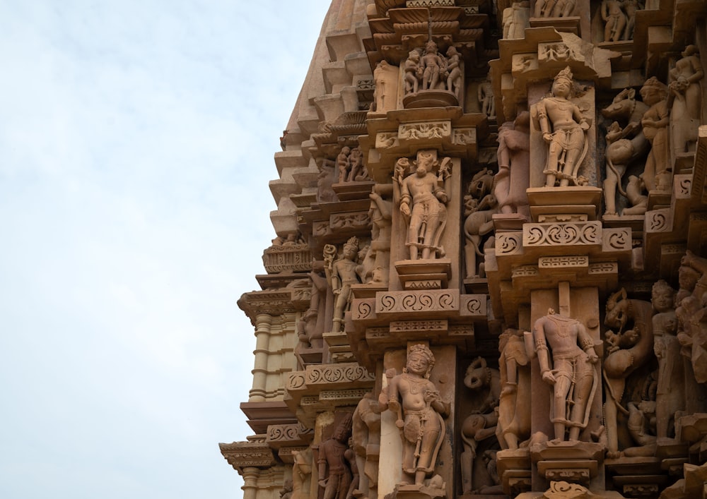 a close up of a building with statues on it