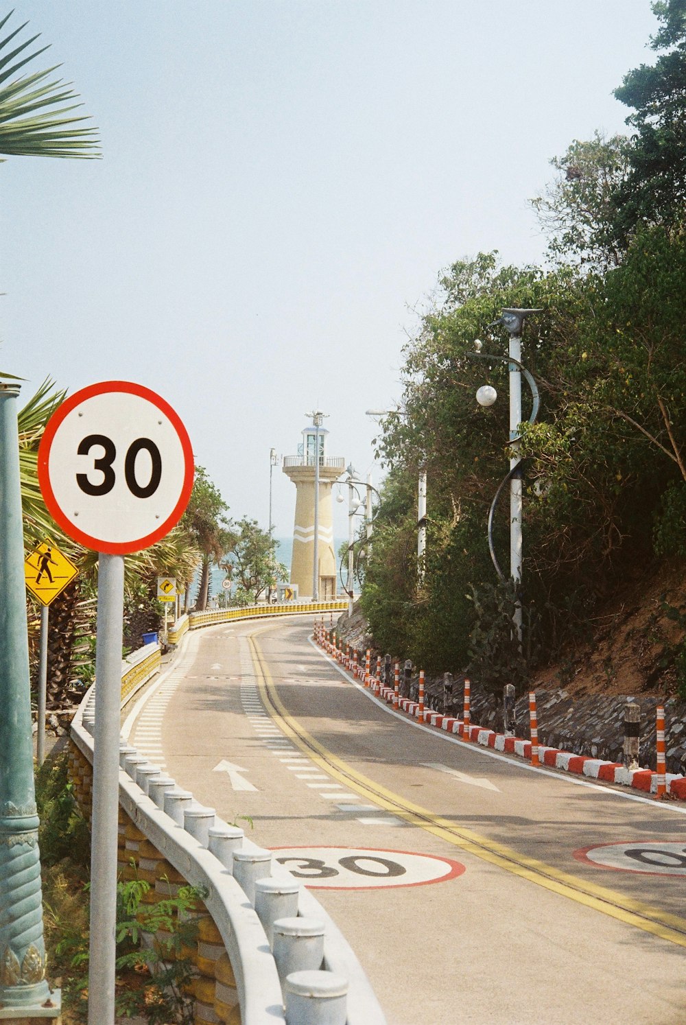 a road with a speed limit sign on the side of it