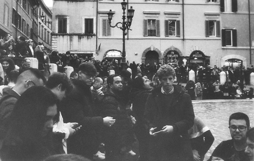 a crowd of people standing around each other