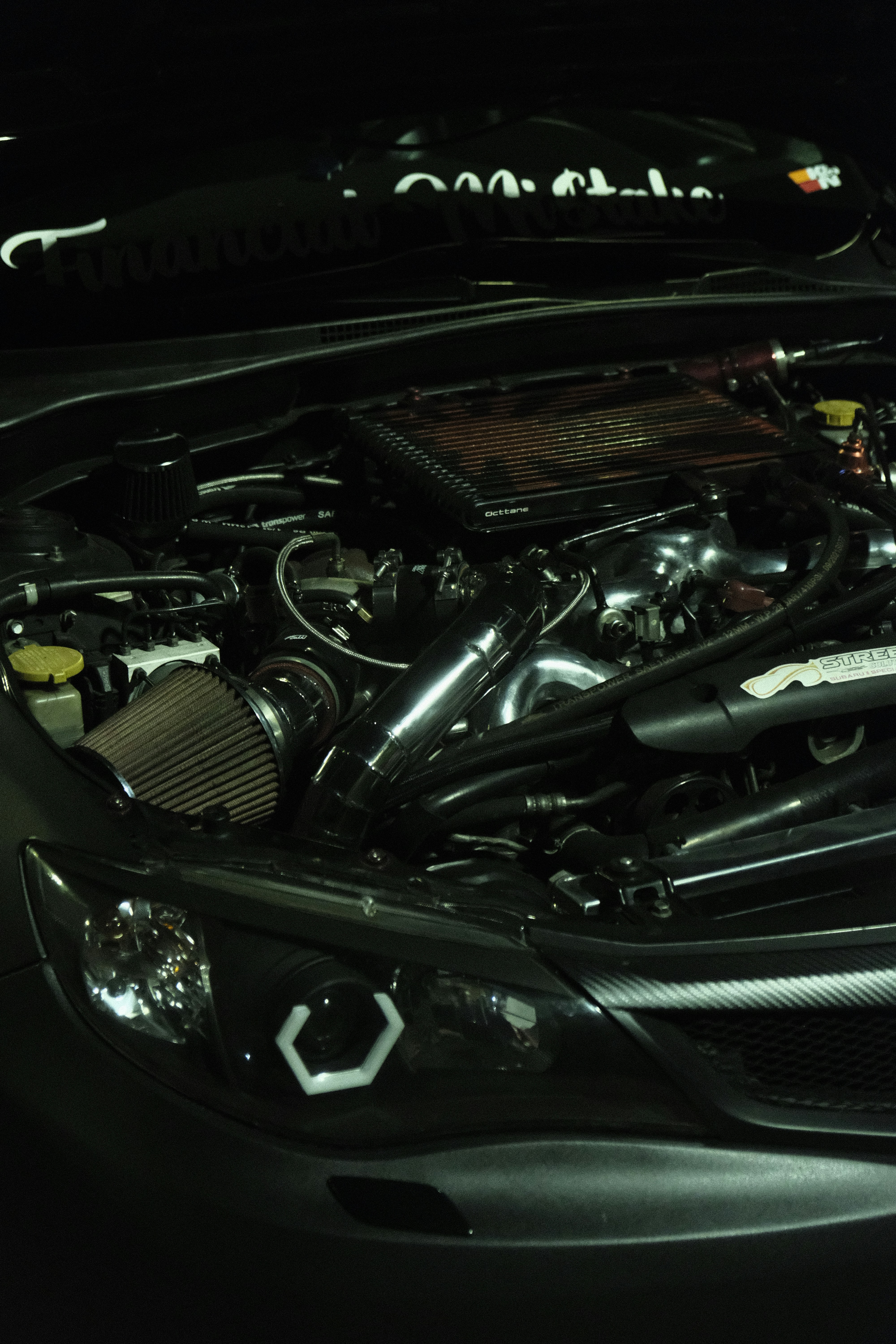Engine air intake system, dark engine bay, atmospheric workshop dim lighting