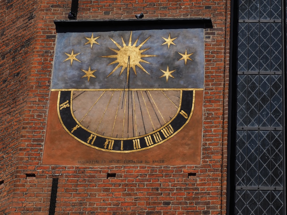 a clock on the side of a brick building