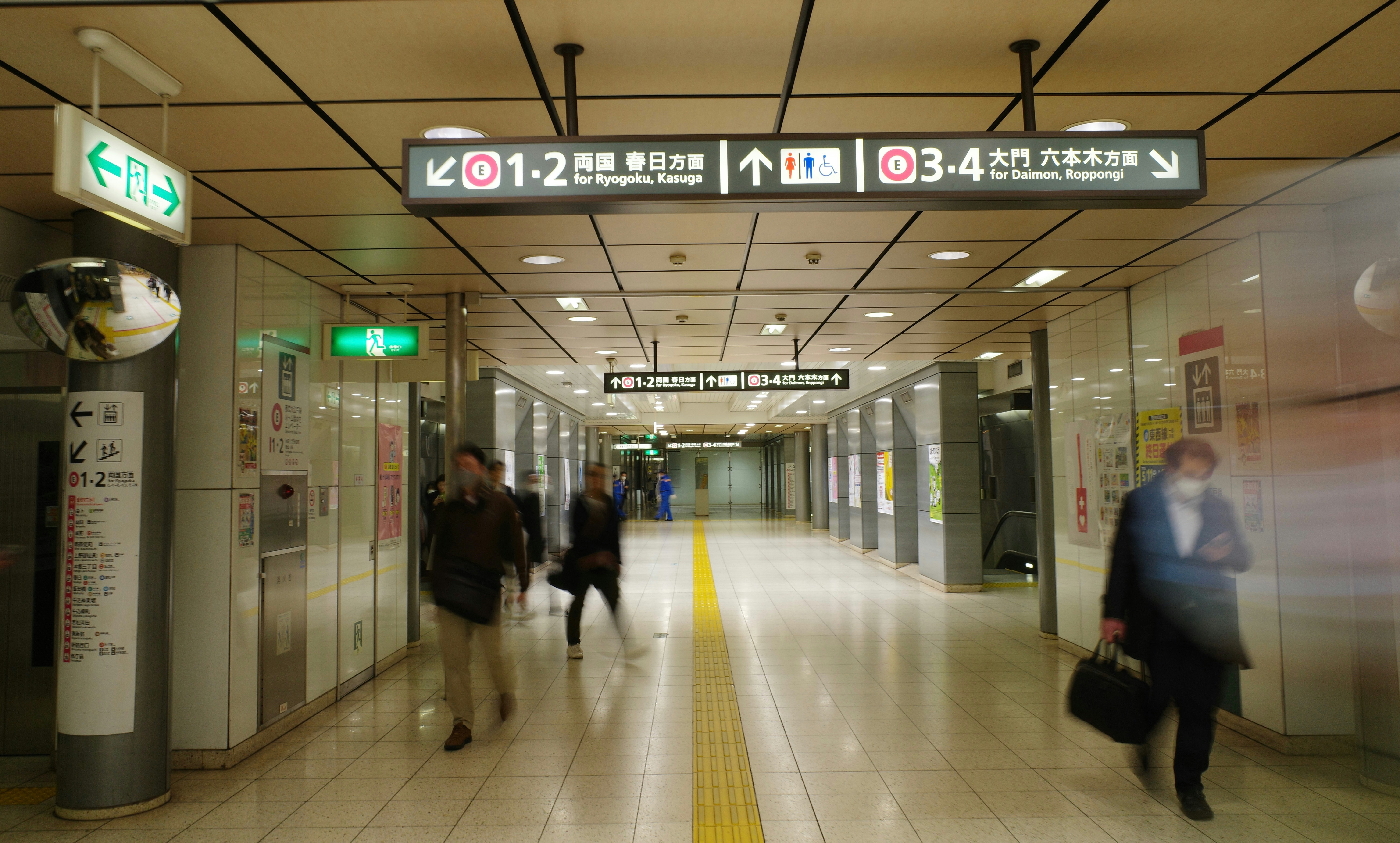 a group of people walking down a hallway, 