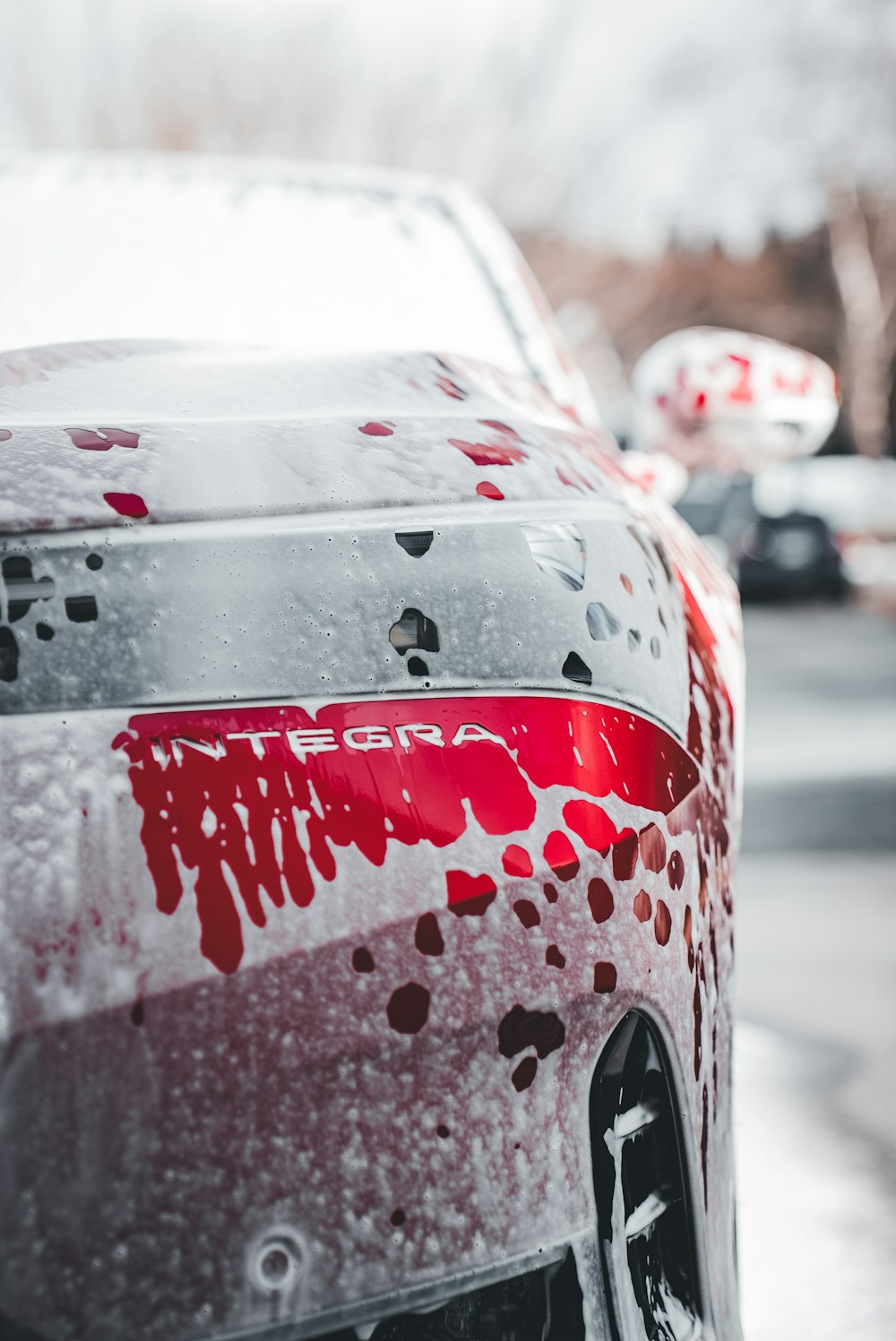 a red and white car covered in snow