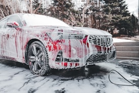 a car is covered in red and white paint
