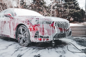 a car is covered in red and white paint