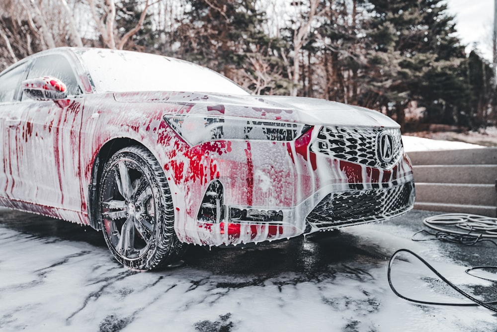 a car is covered in red and white paint