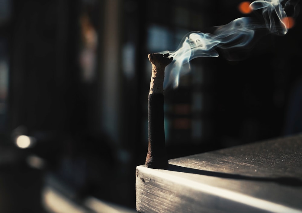 a matchstick with smoke coming out of it