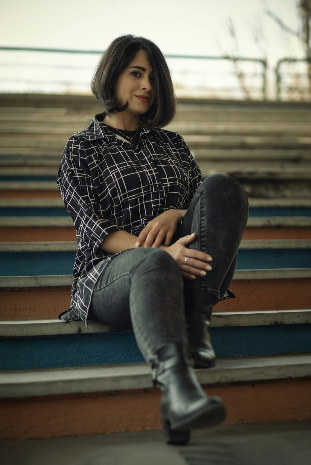 a woman sitting on the steps of a stadium
