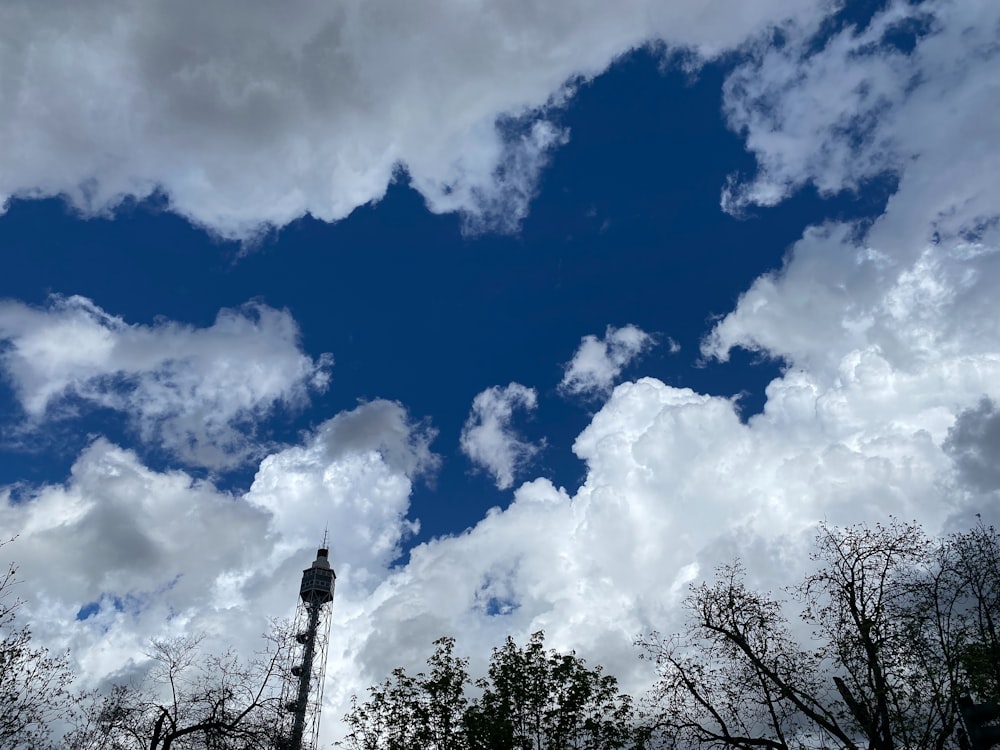 a street light in front of a cloudy blue sky